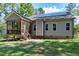 View of the home's backyard, featuring a screened-in porch, patio and solar panels at 3627 River Watch Ln, Franklinton, NC 27525