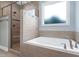 Bright bathroom showcasing a soaking tub and a glass-enclosed shower with tile surround and multiple shower heads at 3627 River Watch Ln, Franklinton, NC 27525
