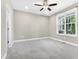 Bright bedroom with neutral walls, plush carpet, and a ceiling fan for added comfort at 3627 River Watch Ln, Franklinton, NC 27525