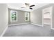 Spacious bedroom with carpet flooring, two windows, and a walk-in closet at 3627 River Watch Ln, Franklinton, NC 27525