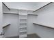 Walk-in closet featuring custom shelving, hanging rods, carpet flooring, and white walls at 3627 River Watch Ln, Franklinton, NC 27525