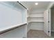 Spacious walk-in closet featuring custom shelving, hanging rods, and carpet flooring at 3627 River Watch Ln, Franklinton, NC 27525