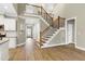 Inviting entryway with staircase and a view into the kitchen at 3627 River Watch Ln, Franklinton, NC 27525