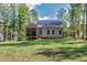 Rear view of home with solar panels and screened in porch at 3627 River Watch Ln, Franklinton, NC 27525