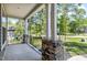 Covered porch with stone accents, white pillars, and black metal railings at 3627 River Watch Ln, Franklinton, NC 27525