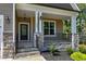 Close-up of the home's entrance showing stone pillars, black railings and lush landscaping at 3627 River Watch Ln, Franklinton, NC 27525