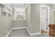 Hallway with a small window, chandelier, and a view into the bathroom at 3627 River Watch Ln, Franklinton, NC 27525