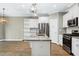 Bright kitchen features stainless appliances, granite counters and white cabinets at 3627 River Watch Ln, Franklinton, NC 27525
