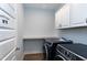 Well-equipped laundry room with modern washer and dryer, plus storage space at 3627 River Watch Ln, Franklinton, NC 27525