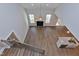 Open floor plan with hardwood flooring, fireplace, and a kitchen island under a vaulted ceiling at 3627 River Watch Ln, Franklinton, NC 27525