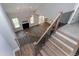 Bright open-concept living space features a fireplace, hardwood floors, and a staircase with black metal railing at 3627 River Watch Ln, Franklinton, NC 27525