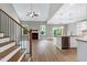 Open-concept living area with a fireplace, abundant natural light, and adjacent kitchen at 3627 River Watch Ln, Franklinton, NC 27525