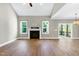 Open living room with fireplace and view of backyard at 3627 River Watch Ln, Franklinton, NC 27525