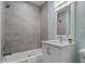 Bathroom featuring a shower-tub, grey tile surround, white vanity and neutral paint at 3932 Old Chapel Hill Rd, Durham, NC 27707