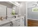 Bright bathroom featuring double sink vanity, quartz countertop, framed mirror, and neutral paint color at 3932 Old Chapel Hill Rd, Durham, NC 27707