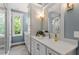 Bright bathroom with double vanity, modern fixtures, and a large window at 3932 Old Chapel Hill Rd, Durham, NC 27707