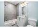 Bathroom featuring gray tile shower and vanity with modern fixtures at 3932 Old Chapel Hill Rd, Durham, NC 27707