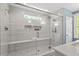Modern bathroom featuring tiled shower with glass enclosure and a built-in bench at 3932 Old Chapel Hill Rd, Durham, NC 27707