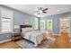 Serene bedroom with light blue walls, hardwood floors, and abundant natural light at 3932 Old Chapel Hill Rd, Durham, NC 27707