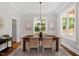 Elegant dining room with hardwood floors, modern chandelier, and sunlit windows at 3932 Old Chapel Hill Rd, Durham, NC 27707