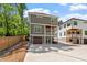 Modern two-story gray home featuring an attached two-car garage and outdoor living spaces at 3932 Old Chapel Hill Rd, Durham, NC 27707