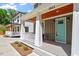 Covered front porch with detailed railings, turquoise door, and wood ceiling at 3932 Old Chapel Hill Rd, Durham, NC 27707