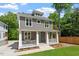 Two-story gray home with covered porch, manicured front lawn, and sunny skies at 3932 Old Chapel Hill Rd, Durham, NC 27707