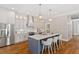 Spacious kitchen featuring stainless steel appliances, a large island, and hardwood floors at 3932 Old Chapel Hill Rd, Durham, NC 27707