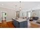 Open-concept kitchen with island seating connecting to the cozy living space at 3932 Old Chapel Hill Rd, Durham, NC 27707