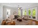 Cozy living room featuring hardwood floors, French doors to a balcony, and ample seating at 3932 Old Chapel Hill Rd, Durham, NC 27707