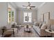 Bright living room featuring neutral tones, large windows, and a ceiling fan at 3932 Old Chapel Hill Rd, Durham, NC 27707