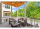 Covered porch with beautiful wood ceiling, white columns and railing, plus comfortable wicker furniture set at 3932 Old Chapel Hill Rd, Durham, NC 27707