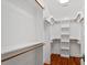 Spacious walk-in closet with custom shelving and hardwood floors at 3932 Old Chapel Hill Rd, Durham, NC 27707