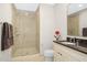 Bathroom featuring a glass-enclosed shower, vanity with granite countertop, and modern fixtures at 400 W North St # 814, Raleigh, NC 27603