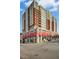 Stunning exterior view of the residential building, highlighting its height, architecture, and red awnings at 400 W North St # 814, Raleigh, NC 27603