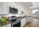 Modern kitchen featuring stainless steel appliances, granite countertops, and white cabinets at 400 W North St # 814, Raleigh, NC 27603