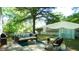 Inviting backyard retreat featuring a stylish patio, comfortable seating, and a charming hammock beneath mature trees at 409 Green St, Sanford, NC 27330