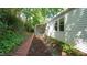 Backyard view featuring a brick retaining wall and side access to the house at 409 Green St, Sanford, NC 27330