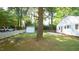 Spacious backyard featuring a storage shed, mature trees, and a white picket fence for added privacy at 409 Green St, Sanford, NC 27330
