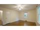 Bedroom with hardwood floors, ceiling fan, and a window providing natural light at 409 Green St, Sanford, NC 27330