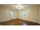 Bright bedroom with hardwood floors, ceiling fan, and two windows providing natural light at 409 Green St, Sanford, NC 27330