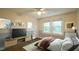 Comfortable bedroom features hardwood floors, lots of natural light and staged entertainment center at 409 Green St, Sanford, NC 27330