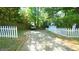 Long gravel driveway with a white picket fence at 409 Green St, Sanford, NC 27330