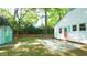 Corner view of the side of the house and the backyard featuring a shed and patio at 409 Green St, Sanford, NC 27330