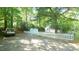 Side view of house featuring a long gravel driveway, picket fence and shed at 409 Green St, Sanford, NC 27330