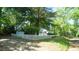 Well-maintained exterior featuring a home, shed, and lush greenery, creating a peaceful and inviting ambiance at 409 Green St, Sanford, NC 27330