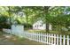 A charming home with a white picket fence, a shed, and mature trees creating a serene setting at 409 Green St, Sanford, NC 27330