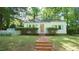 Charming single-story home with a well-maintained lawn, brick walkway, and a classic white picket fence at 409 Green St, Sanford, NC 27330