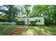 Charming single-story home with a brick walkway, a well-manicured lawn, and a classic white picket fence at 409 Green St, Sanford, NC 27330