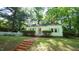 Charming single-story home with a brick walkway, a well-manicured lawn, and a classic white picket fence at 409 Green St, Sanford, NC 27330